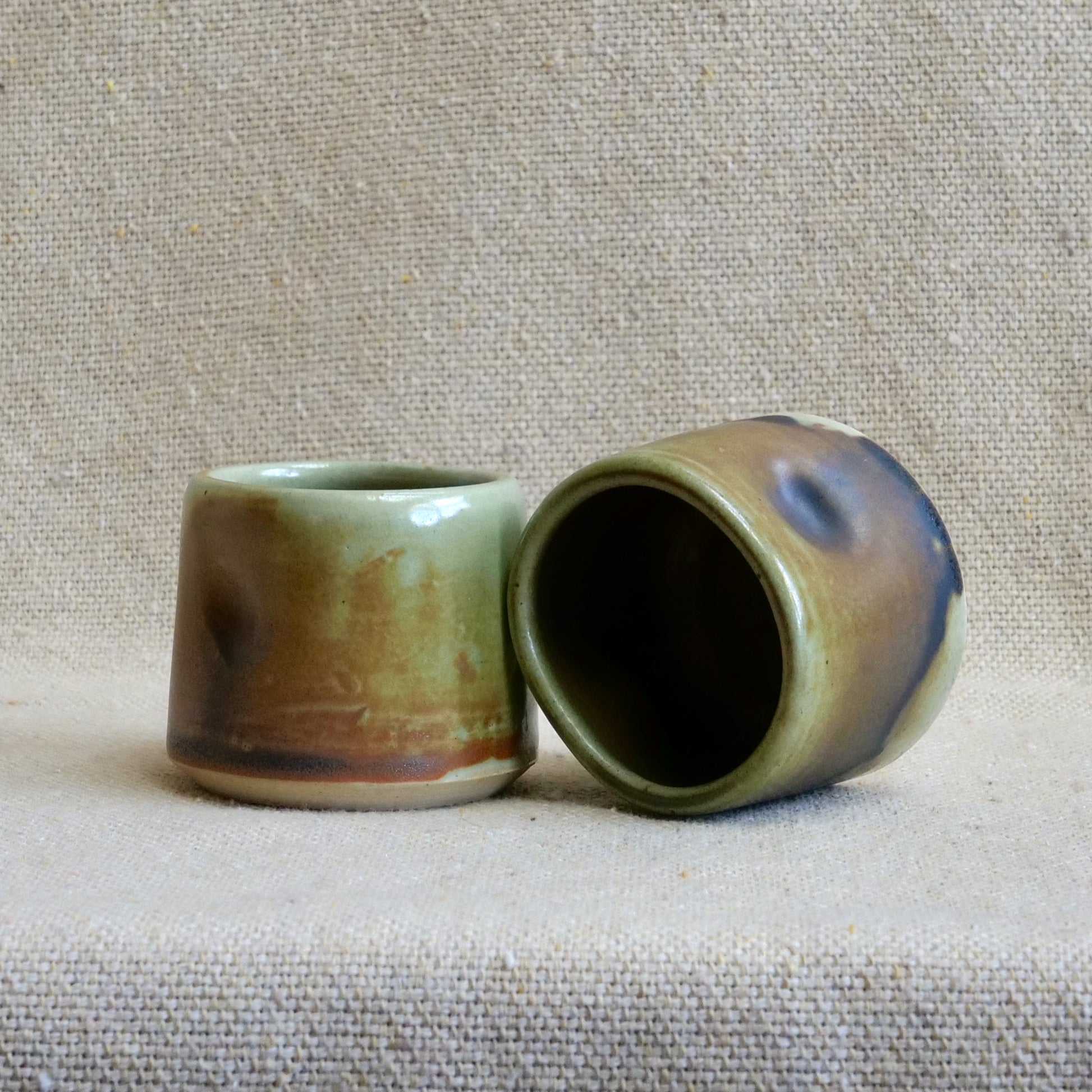 handmade ceramic espresso cortado cup, earthy matte rusty orange black glaze, pinch cup, thumb cup, pottery