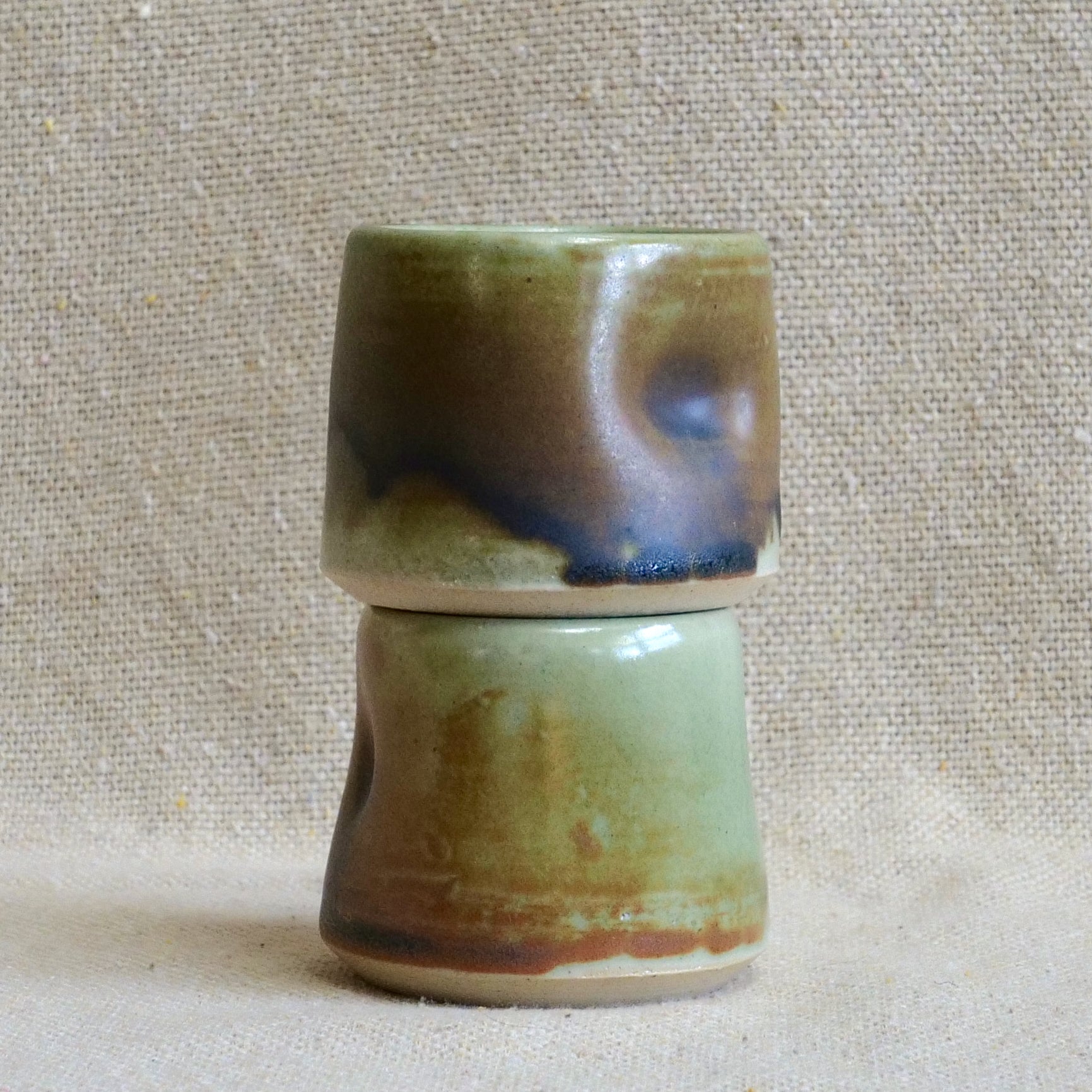 handmade ceramic espresso cortado cup, earthy matte rusty orange black glaze, pinch cup, thumb cup, pottery