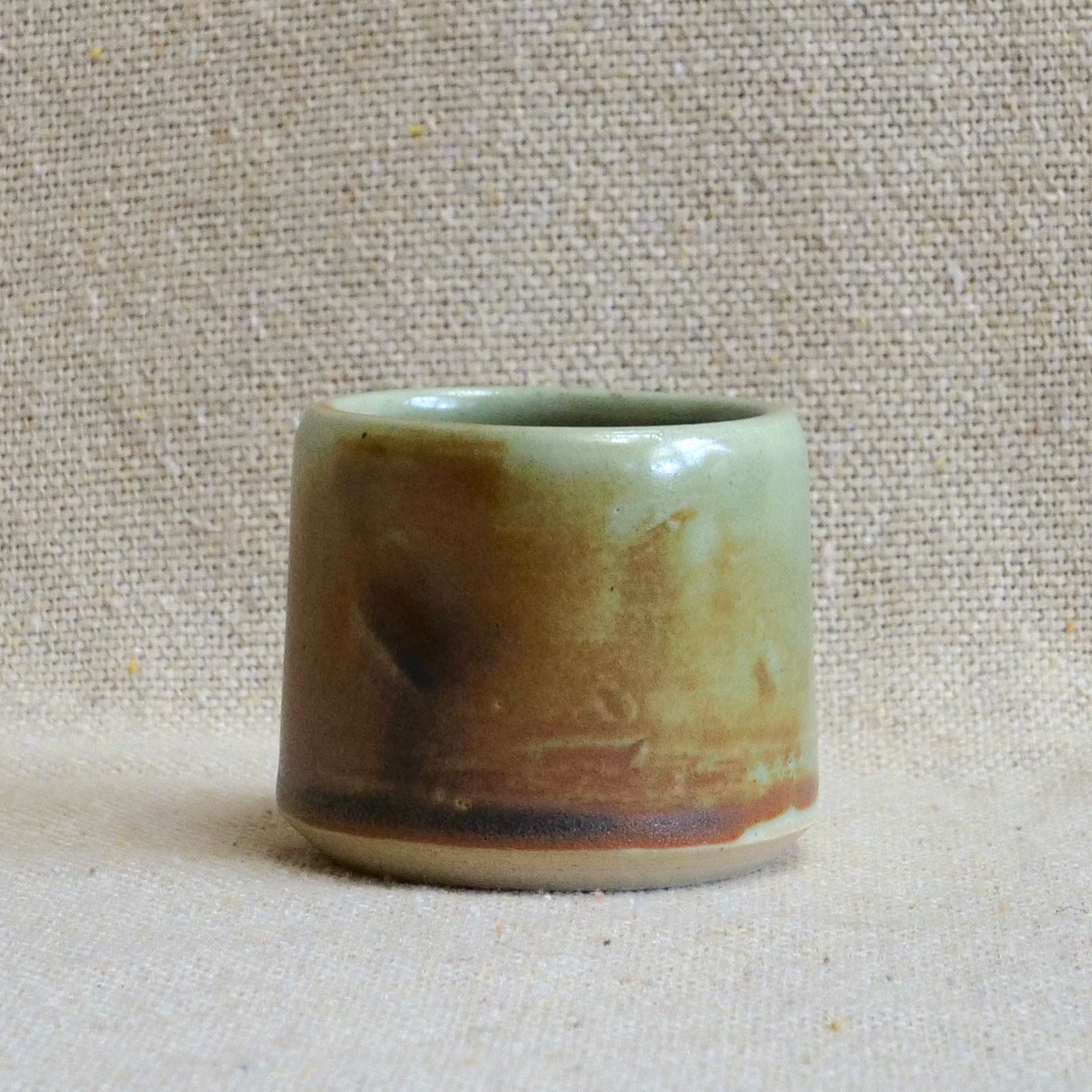 handmade ceramic espresso cortado cup, earthy matte rusty orange black glaze, pinch cup, thumb cup, pottery