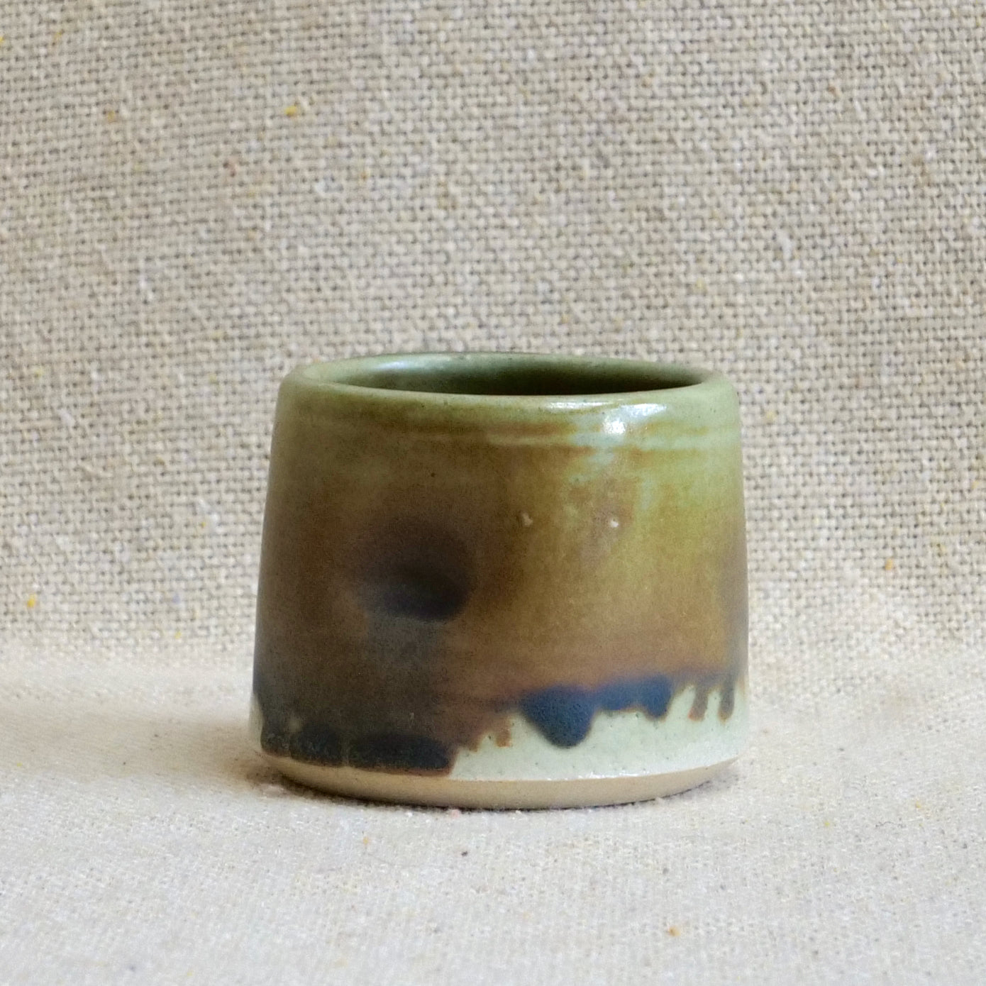 handmade ceramic espresso cortado cup, earthy matte rusty orange black glaze, pinch cup, thumb cup, pottery