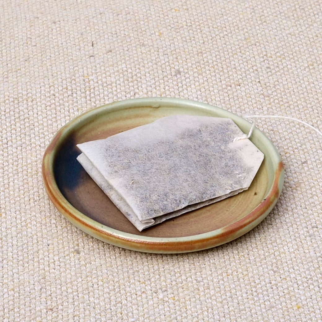 tiny handmade ceramic plate, teabag holder, trinket dish, earthy rusty black matte glaze, wheel thrown