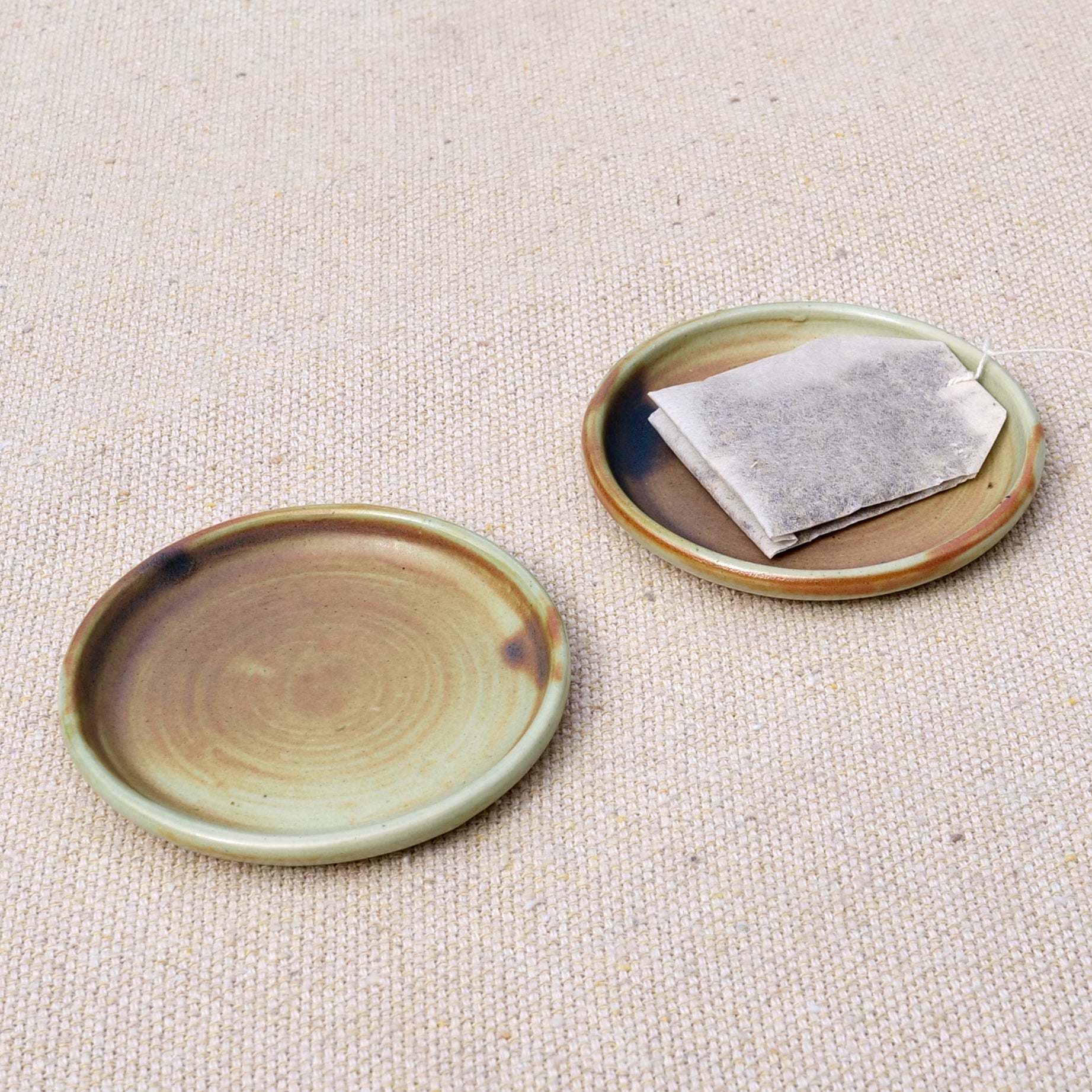 tiny handmade ceramic plate, teabag holder, trinket dish, earthy rusty black matte glaze, wheel thrown