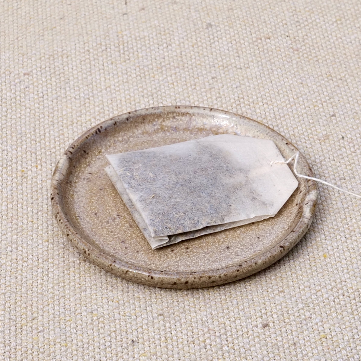 tiny handmade ceramic plate, teabag holder, trinket dish, earthy neutral granite speckled pattern, wheel thrown